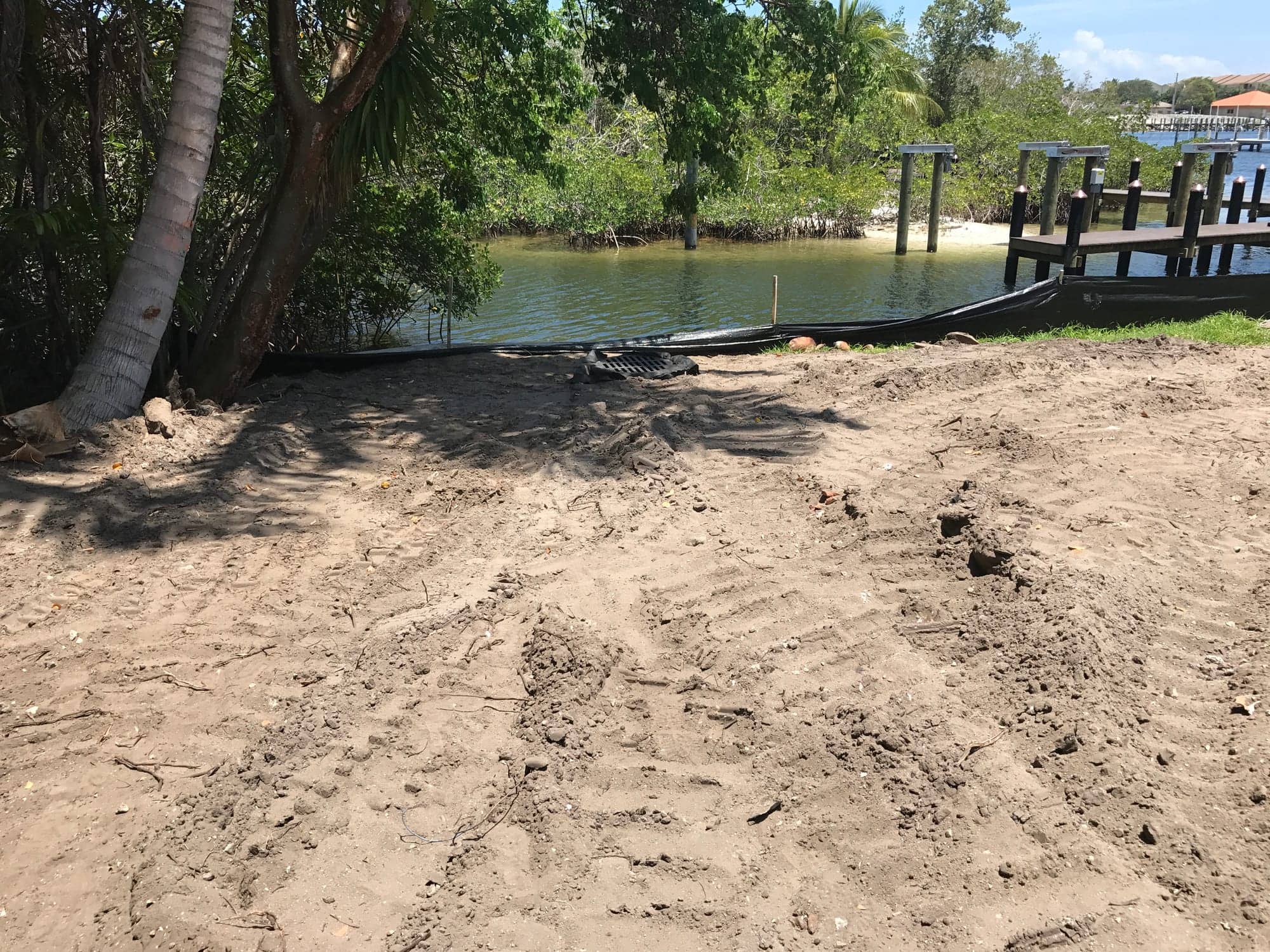 Cleared waterfront lot with dock and Intracoastal beyond, prepared for construction