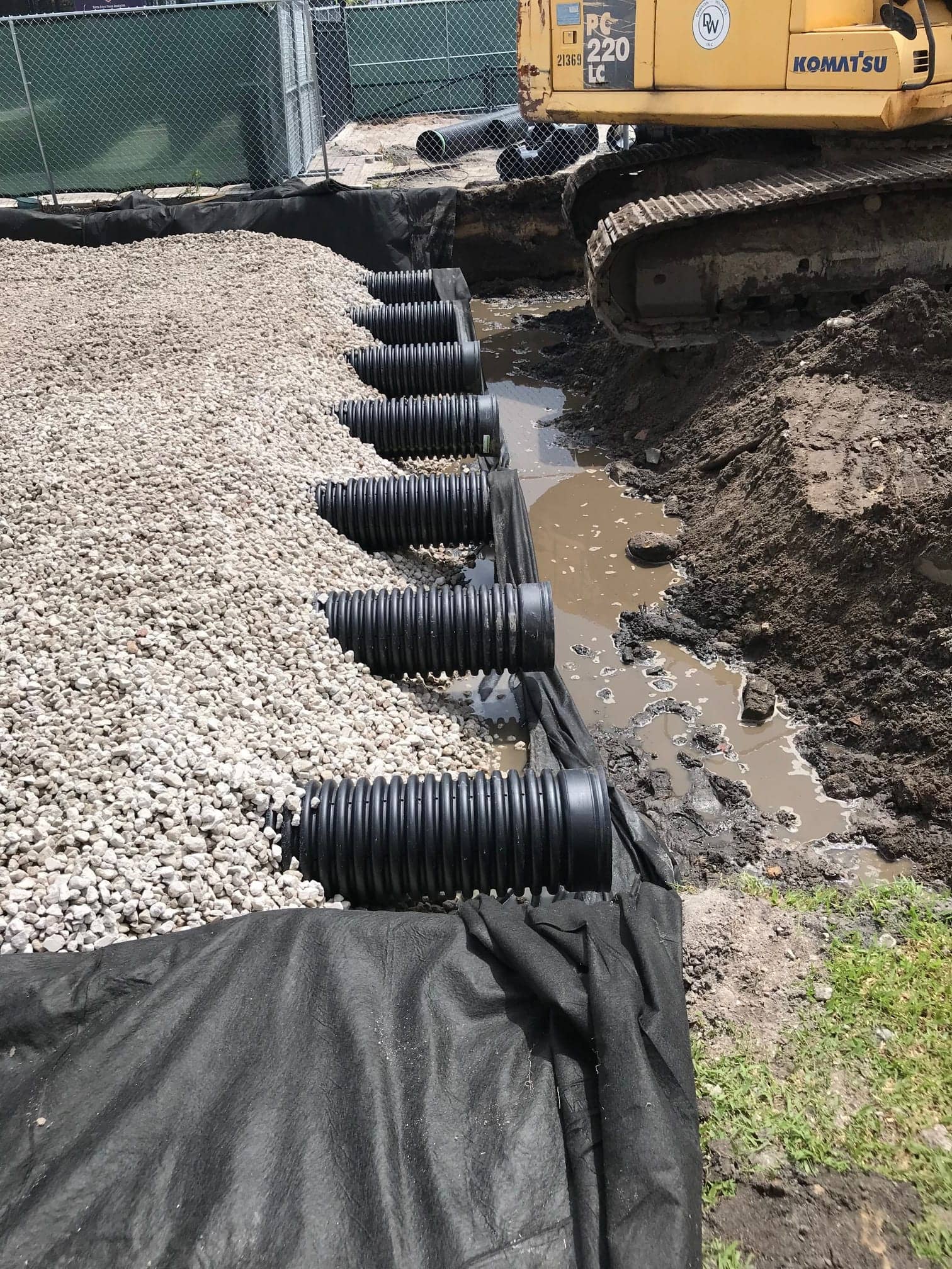 Exfiltration pipe and gravel bed being installed on a Palm Beach County site
