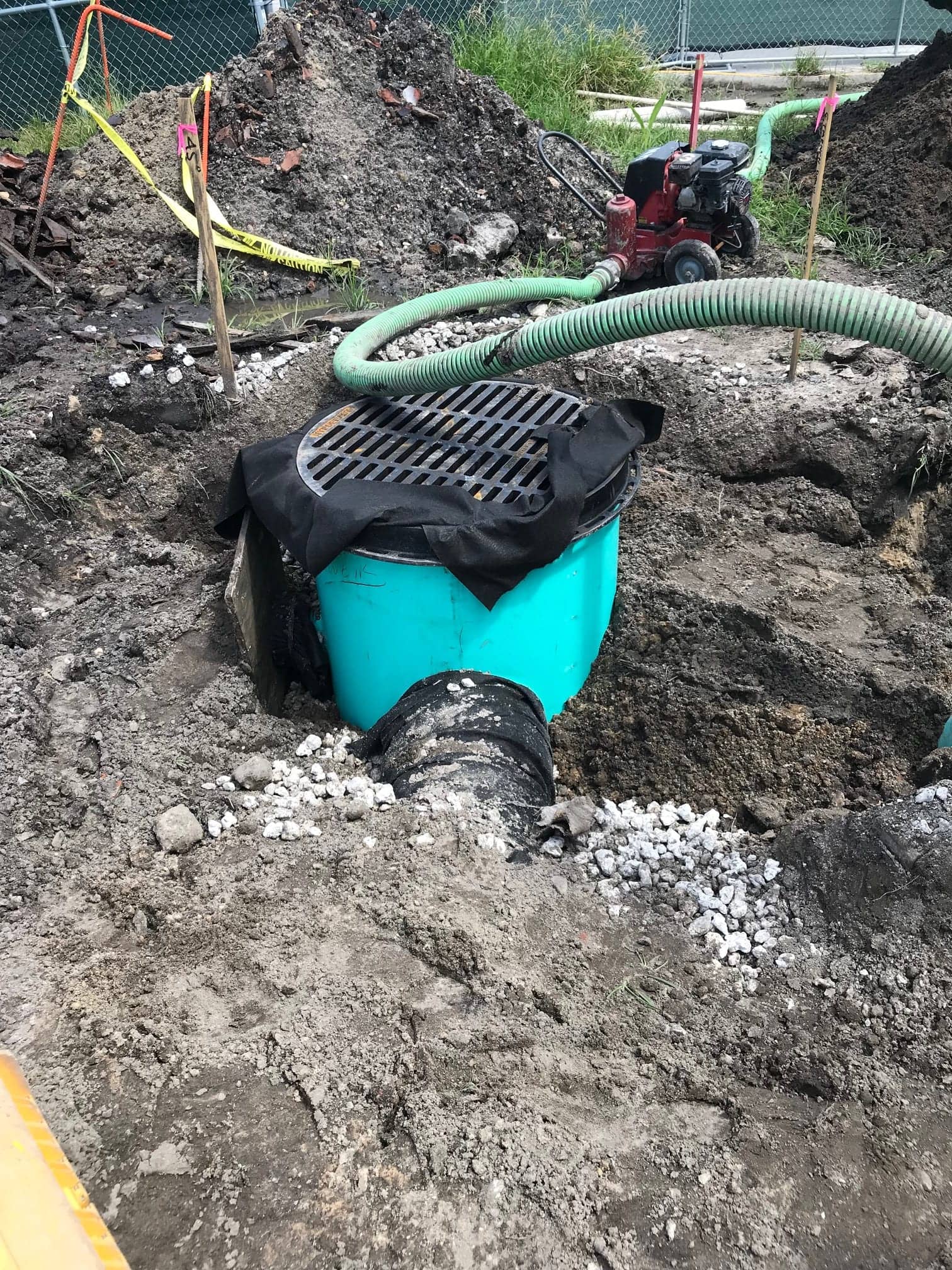 Stormwater drainage structure and exfiltration pipe being installed on a waterfront lot